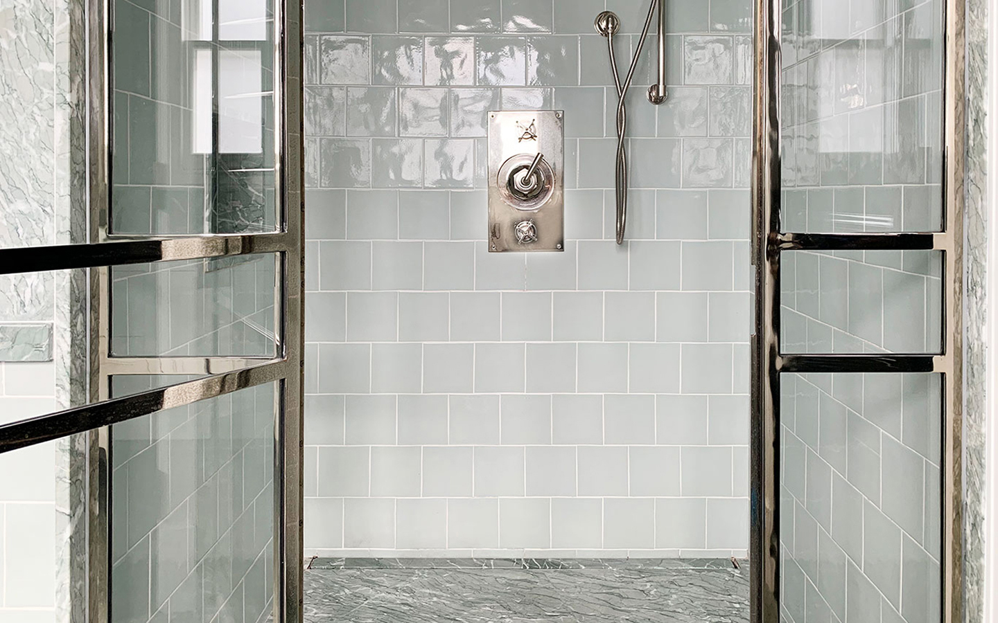 Walk in shower with metro tiles and honed Verde Antigua shower tray